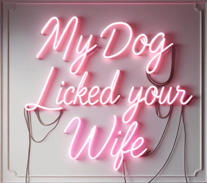 My Dog Licked Your Wife real glass neon sign in coral pink and white, handcrafted in Los Angeles, edgy decor piece.
