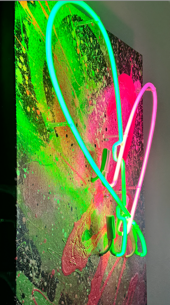 Two-tone neon heart wall décor with split pink and green neon glow